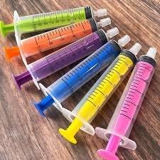 Plastic colored syringe